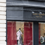 Exterior storefront of a boutique with a mannequin in the window, representing the best places to shop for petite clothing stores.
