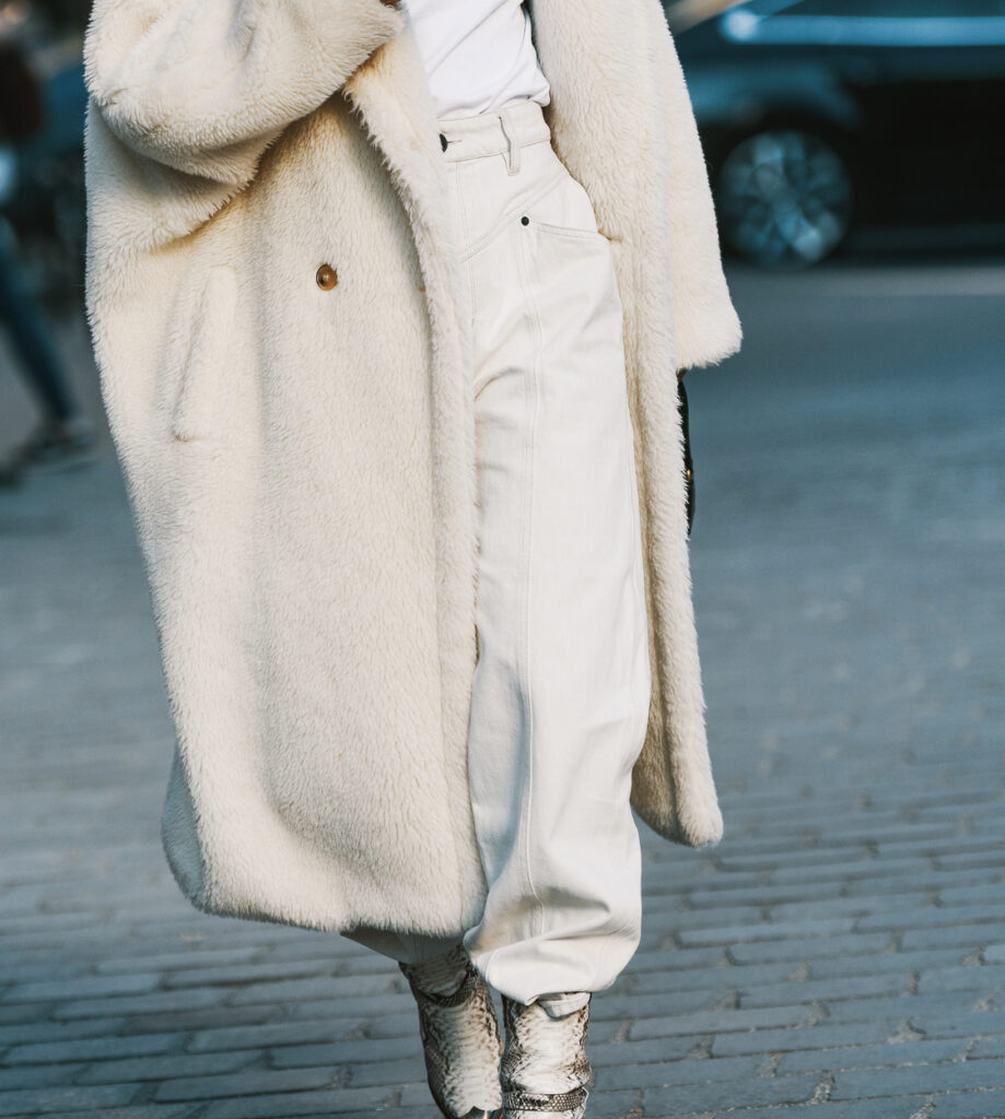 Curvy petite wearing cream colored barrel leg pants