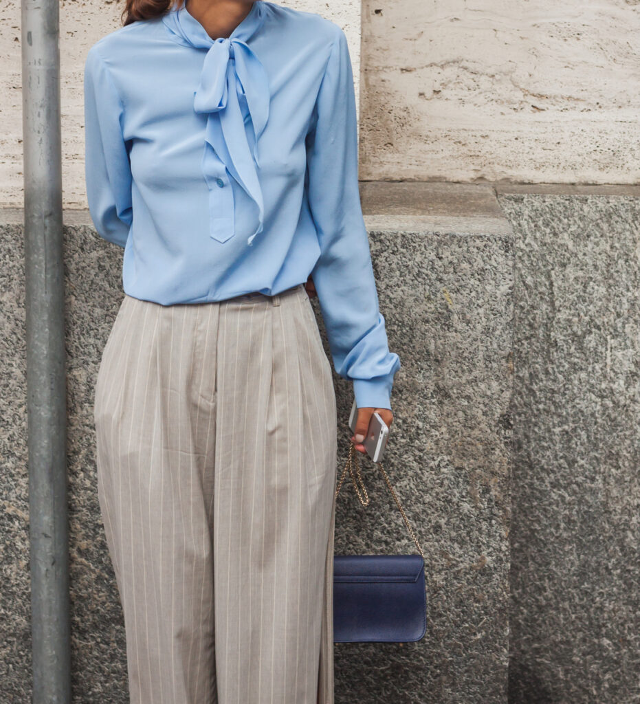 Fashionable Curvy Petite wearing high waisted pants and dress blouse
