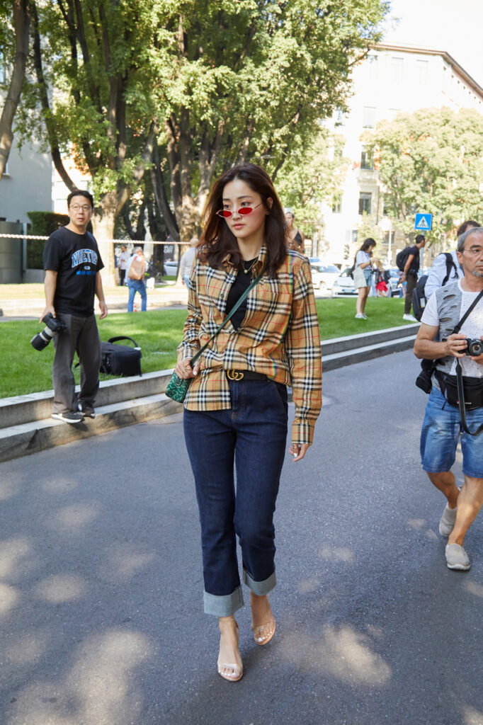 A stylish Petite with her blouse tucked in to create a more flattering outfit
